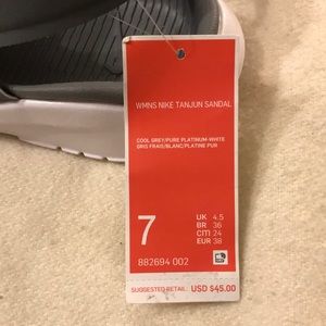 Gray and white Nike sandals